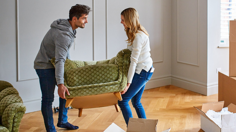 couple moving green chair