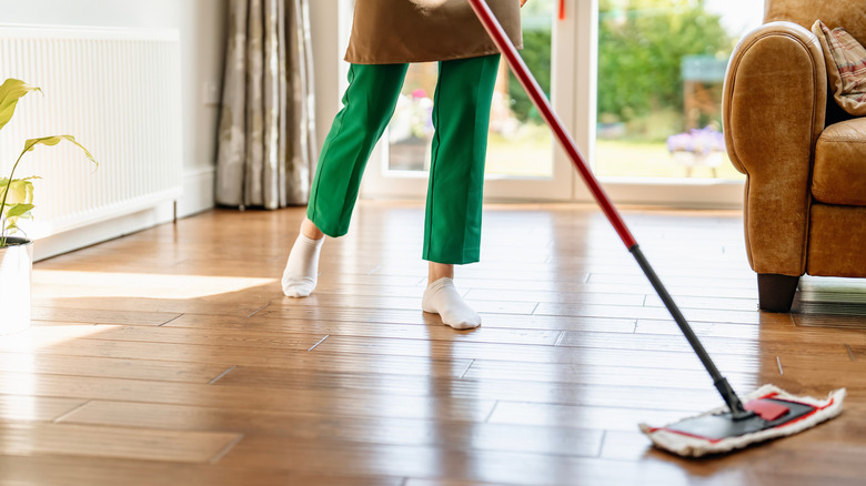 Person mopping hardwood floors