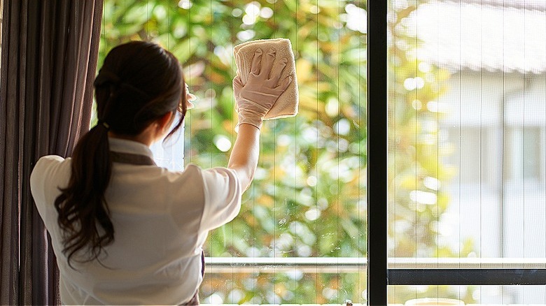 Person wiping glass