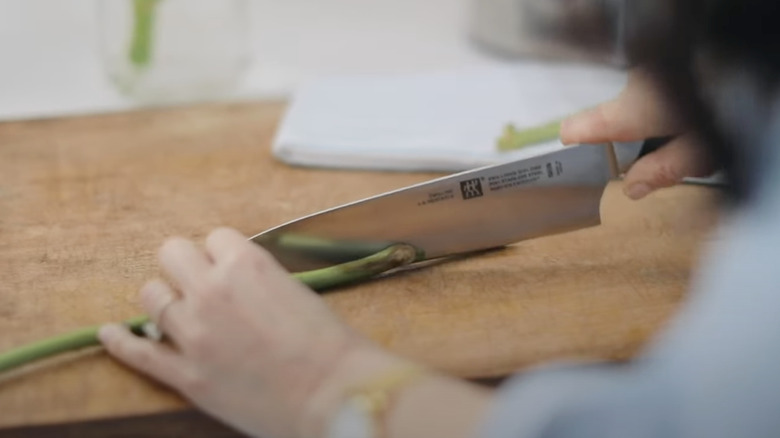 Cutting hydrangea stem with a knife