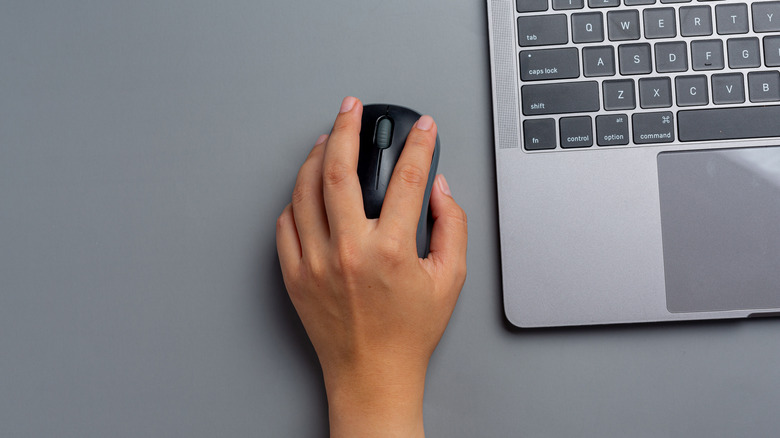 Hand clutching computer mouse