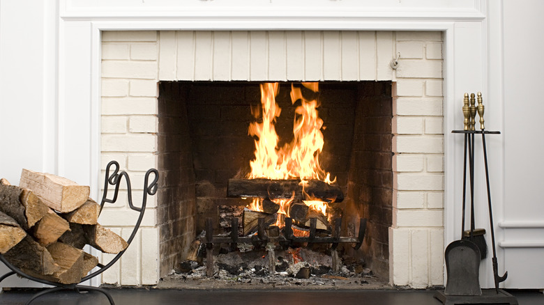Open flame white brick fireplace