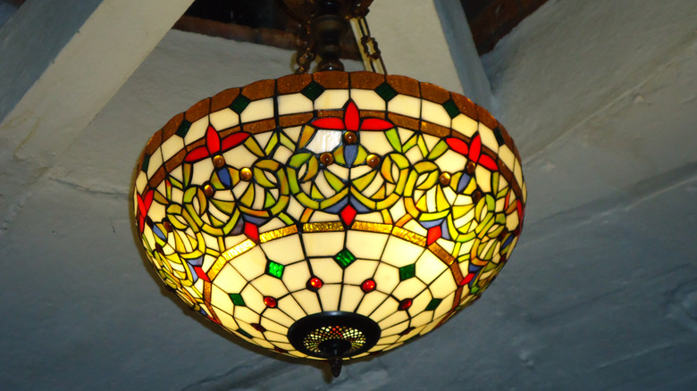 Close up of tiffany stained glass chandelier on ceiling.