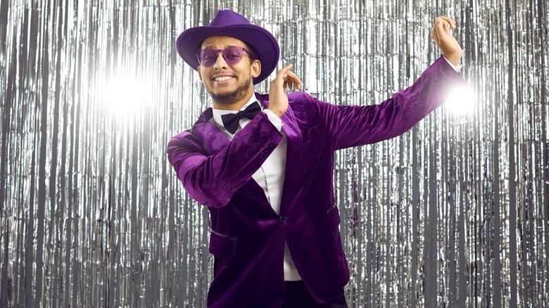 man in purple tuxedo dancing