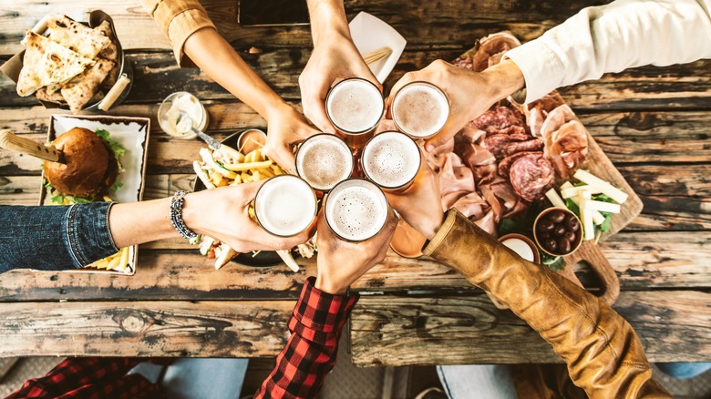 friends toasting over wooden table