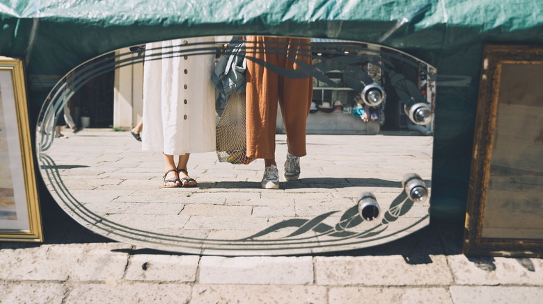 women in reflection flea market