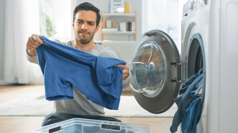 Man removing clothes from dryer 