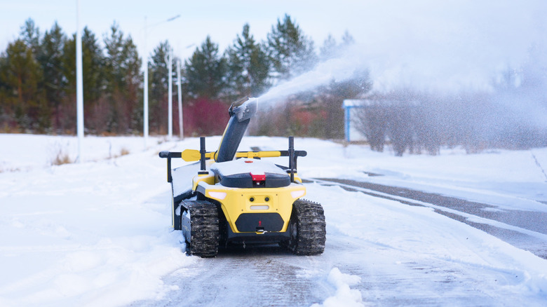 Yarbo's robotic snow blower blowing snow off of driveway