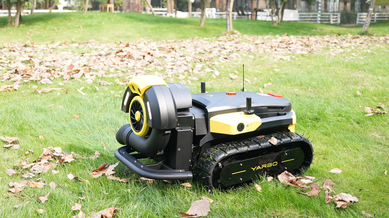 Yarbo's robotic leaf blower in grassy lawn with leaves