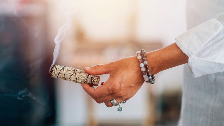 woman using a smudge stick