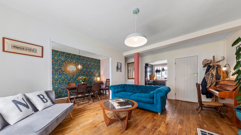 Bold blue couch in wood and white room