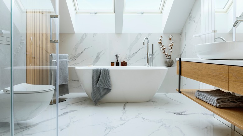 marble bathroom with white bathtub