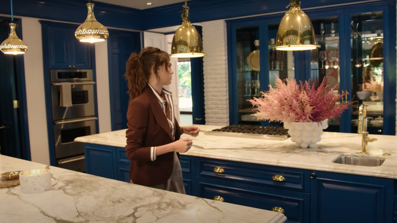 Cara Delevingne in blue kitchen