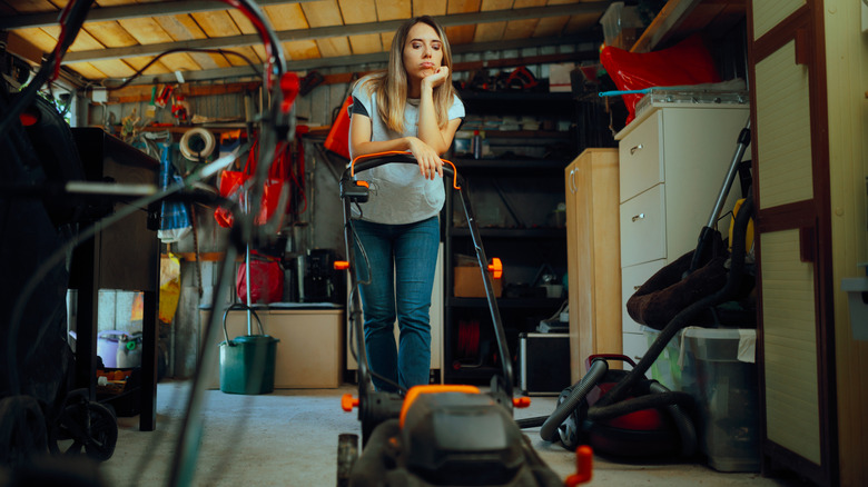 person looking at their lawn mower
