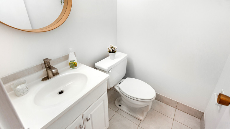 A half-bath with toilet and single-vanity sink is shown.