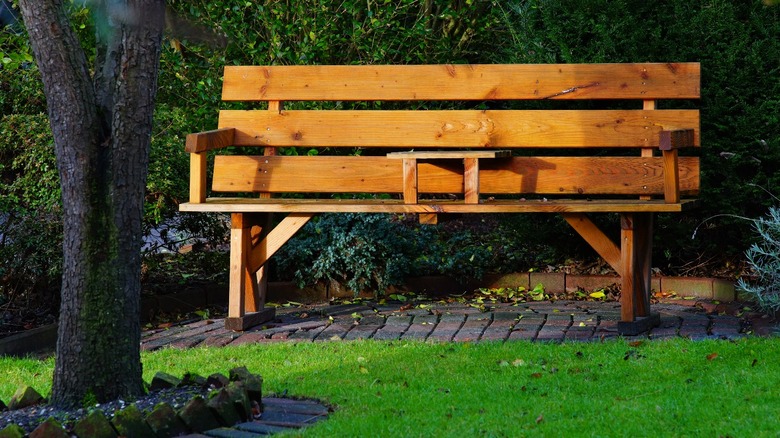 wooden garden bench on stone