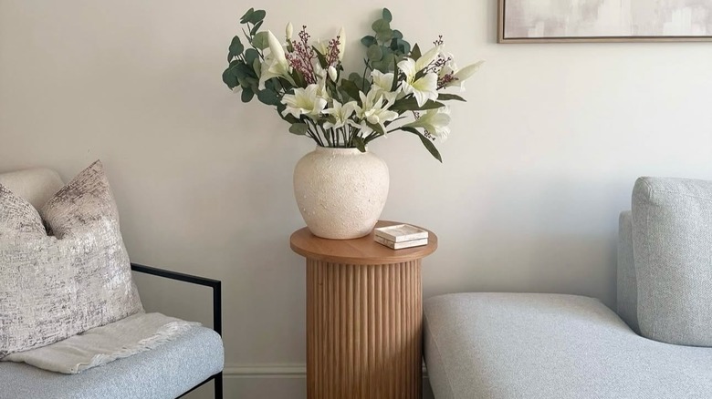 Wood stand with a base and greenery on top
