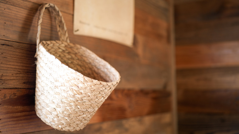 Woven basket hanging from a wall