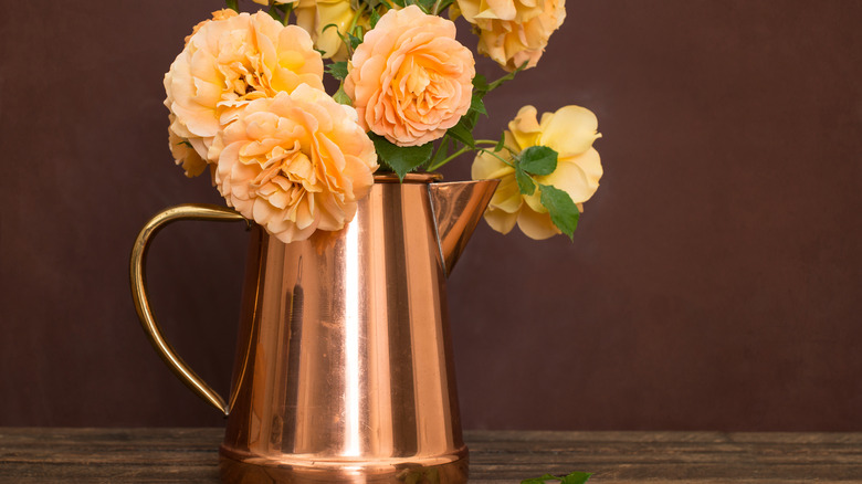 Copper vase with roses