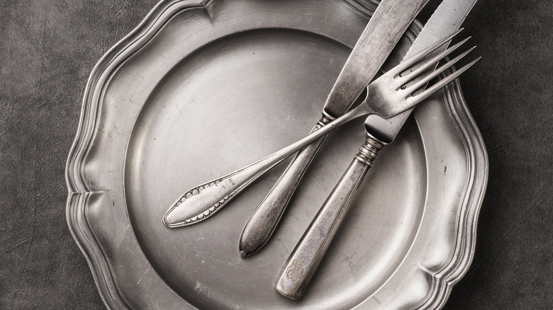 cutlery on a pewter plate