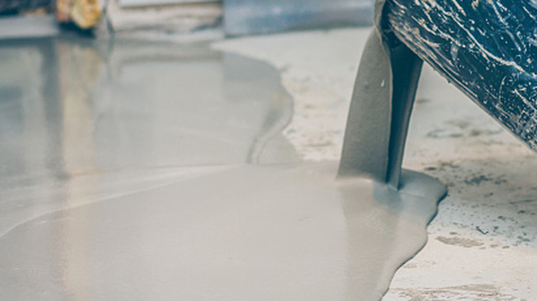 Person pouring self-leveling concrete