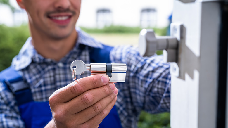 Locksmith holding cylindrical lock