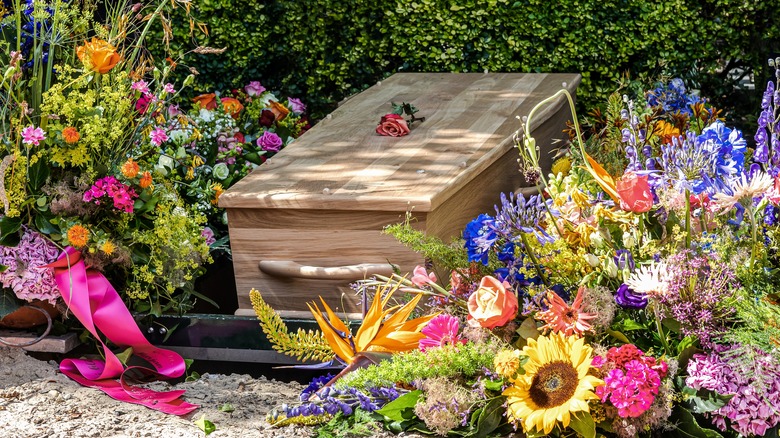 coffin surrounded by flowers