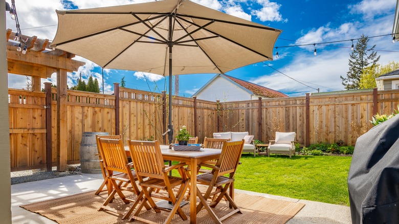 patio furniture in backyard with umbrella