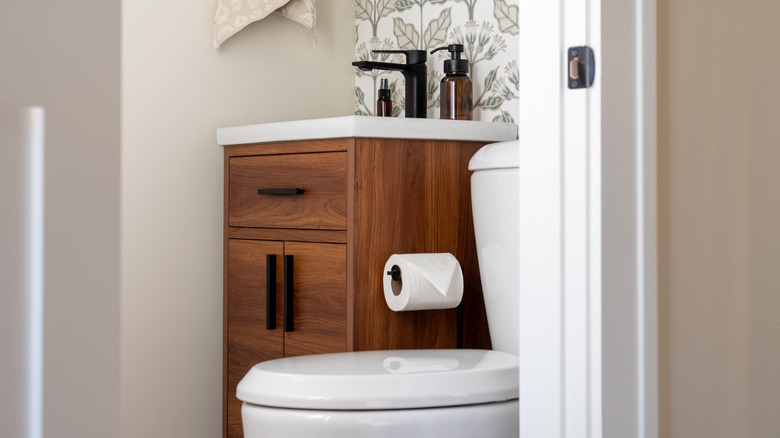 decorative half bathroom with sink and toilet