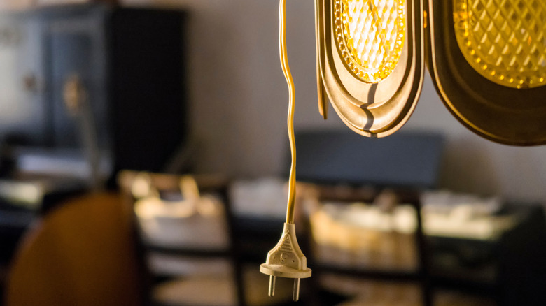 An old electrical cord hangs from a lamp