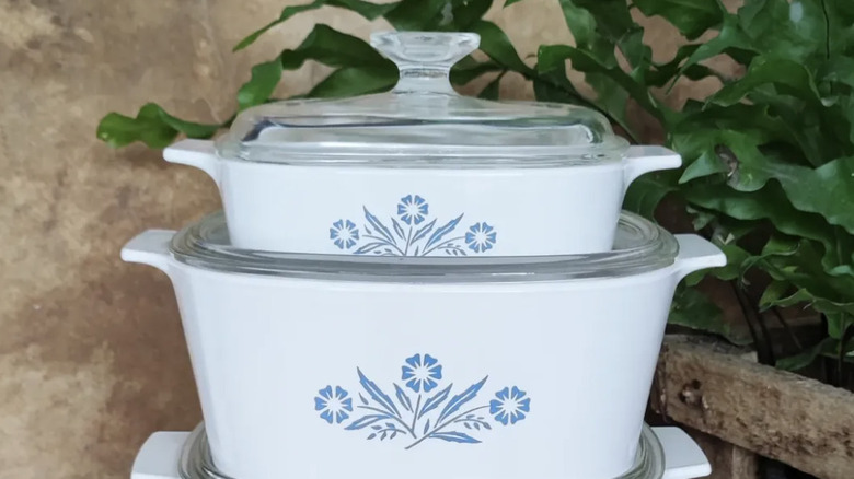 A collection of Blue Cornflower CorningWare casserole dishes of varying sizes sitting atop one another