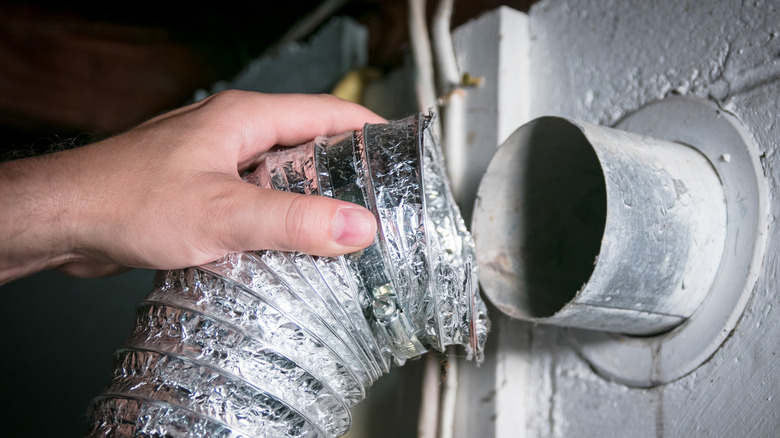 A dryer duct in a person's hand