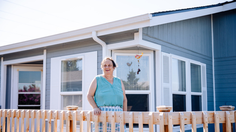 Woman standing in front of a manufactured home