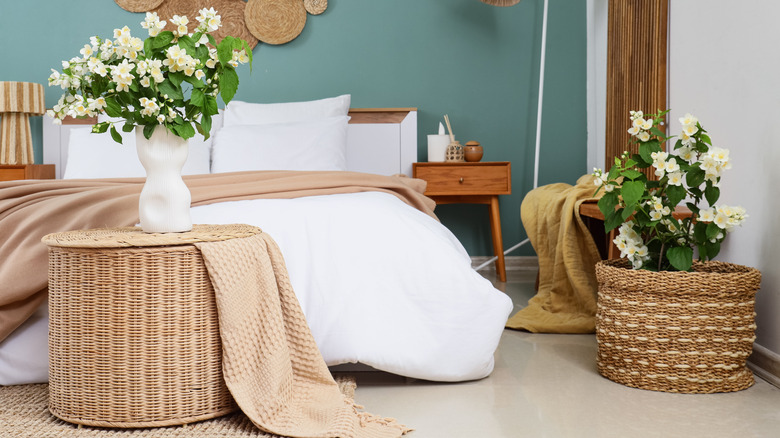 A bedroom with wicker baskets and a wicker decoration above the bed