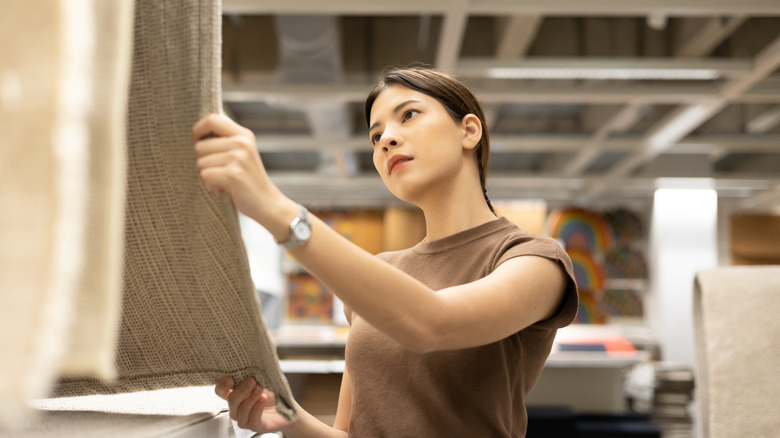 Person shopping for rugs