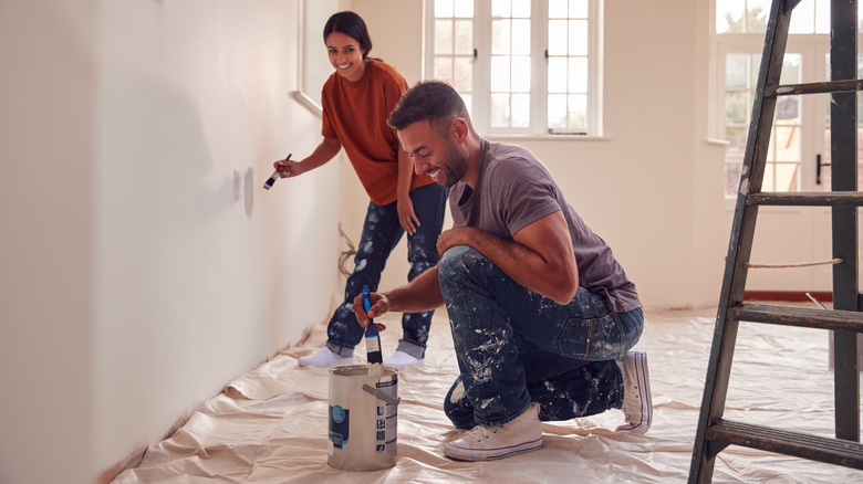 Couple painting on wall