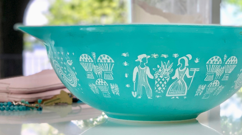 A vintage pyrex bowl with a colorful surface