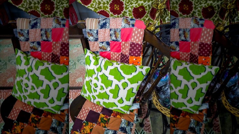 Quilt and pillow placed on wooden chair at a thrift store