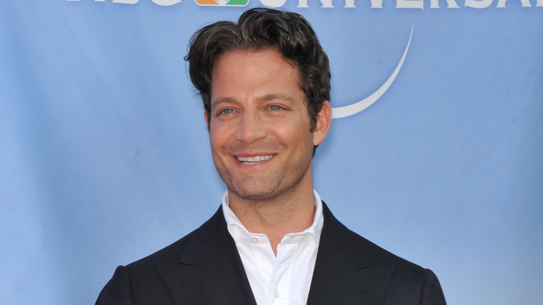 Nate Berkus smiling with a blue background