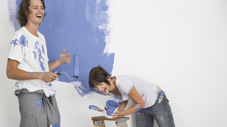 Friends painting a wall