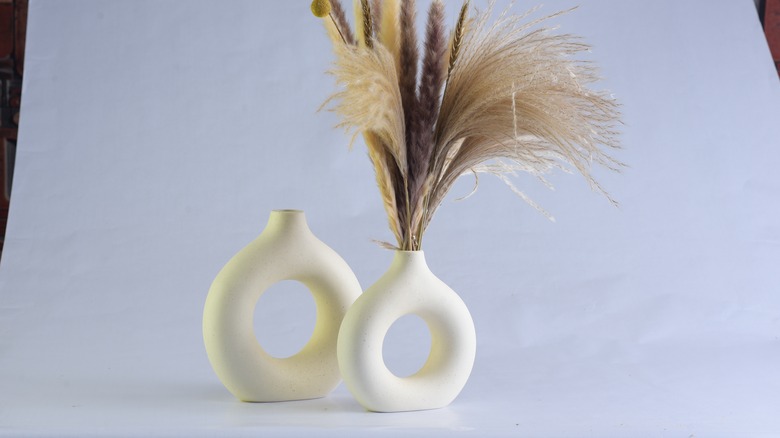 two donut vases with dried flowers