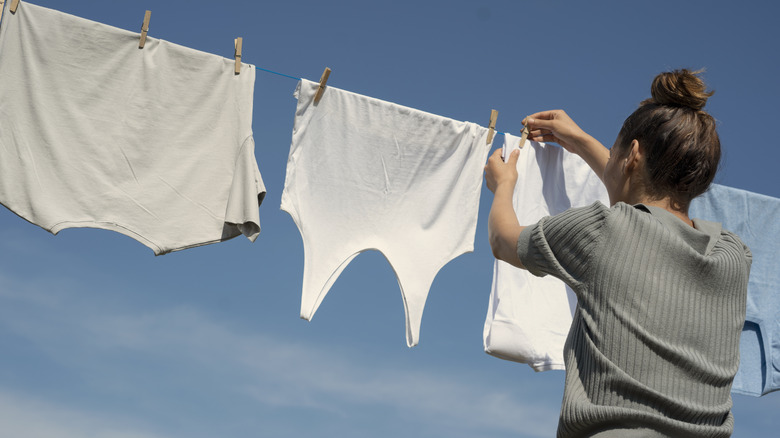 Person hanging clothes to dry on clothes line