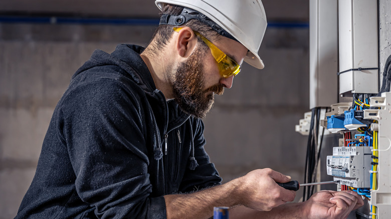 Electrician works on a home electrical unit