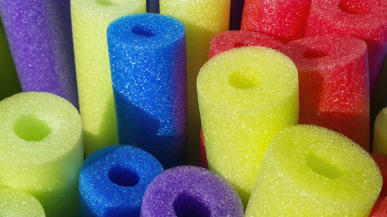 multicolored pool noodles standing up