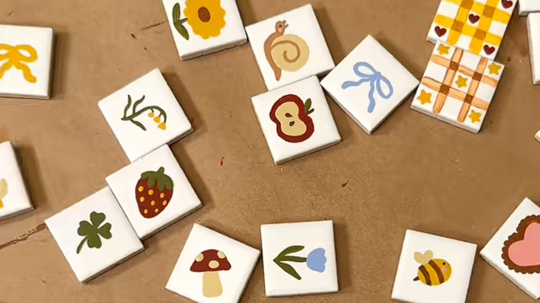 Ceramic tiles hand painted with fruit, animal, and flower designs
