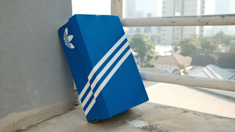 Blue Adidas shoe box against wall