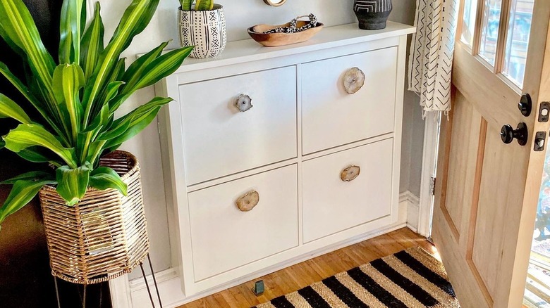 An IKEA shoe cabinet with upgraded handles near an entryway