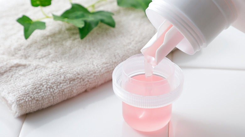 fabric softener pouring into cup