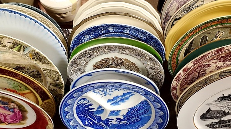 An assortment of vintage plates at a thrift store