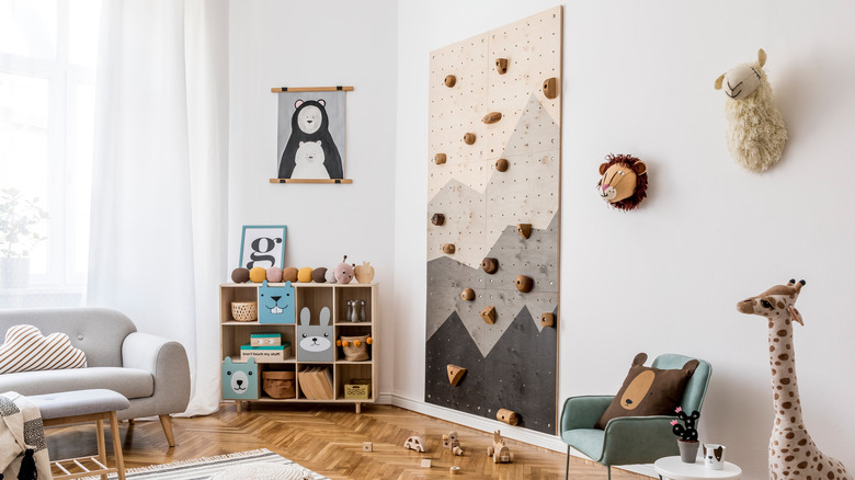 a well decorated children's room with a climbing wall